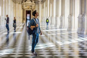 man looking at art in a museum